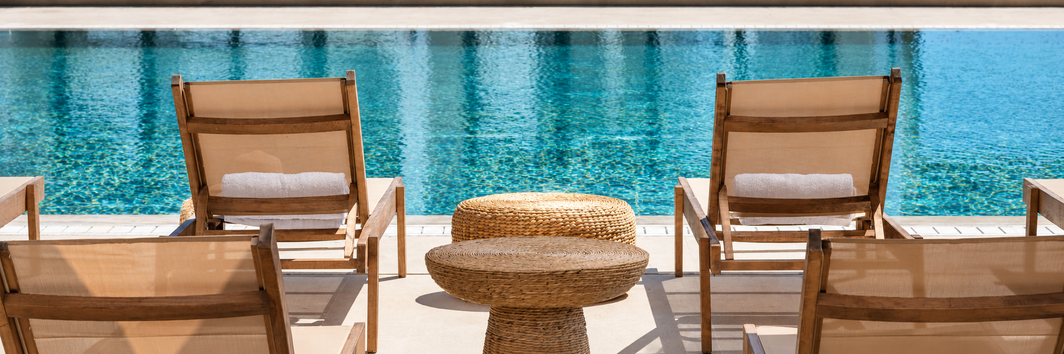 turquoise-hotel-pool-with-woven-loungers-1-